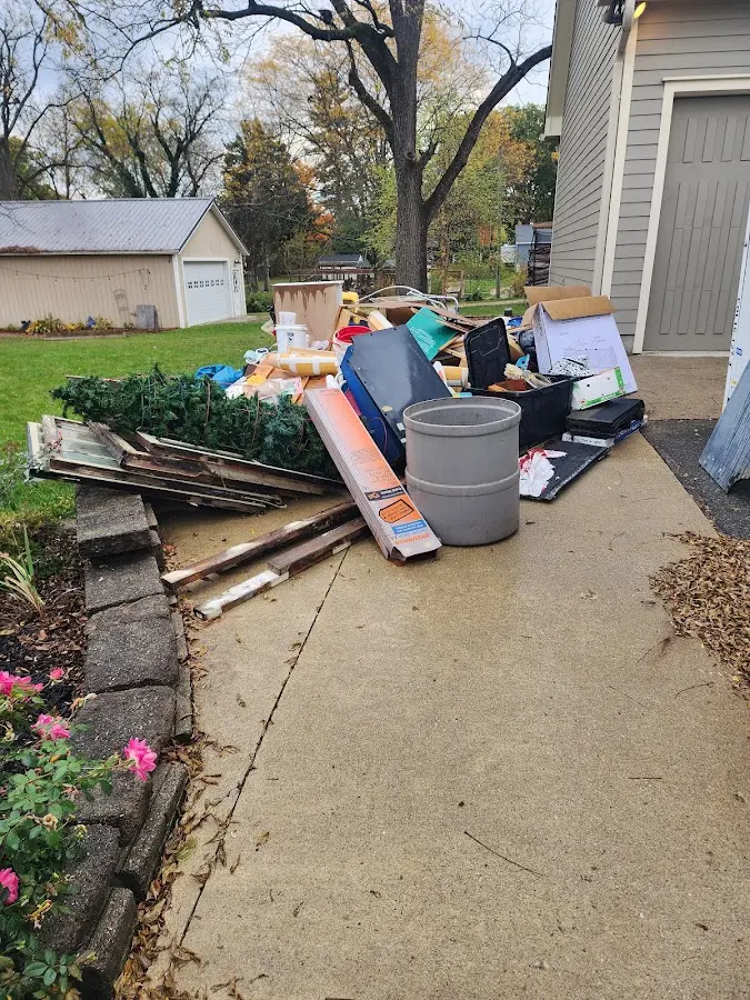 Dumpster being loaded with debris for Residential Dumpster Rental in Buford